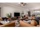 Spacious living room featuring comfortable seating, a modern TV, and adjacent dining area at 3301 E Sharon Dr, Phoenix, AZ 85032