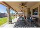 Enjoy the covered patio with ceiling fans, a patio set, and access to the backyard at 3301 E Sharon Dr, Phoenix, AZ 85032