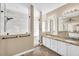 This bathroom features a double sink with granite countertops, white cabinetry, and a large walk-in shower at 3443 E Thornton Ave, Gilbert, AZ 85297