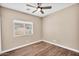 This bedroom features a ceiling fan and a large window at 3443 E Thornton Ave, Gilbert, AZ 85297