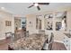 Open dining area with a view into a living space with a fireplace and an office space at 3443 E Thornton Ave, Gilbert, AZ 85297