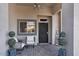 Inviting front porch with seating, decor and a security screen door at 3443 E Thornton Ave, Gilbert, AZ 85297