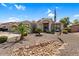 Charming single-story home with desert landscaping, palm trees and a welcoming facade at 3443 E Thornton Ave, Gilbert, AZ 85297