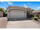 Single-story home with a large two car garage, desert landscape, and well-kept lawn at 3443 E Thornton Ave, Gilbert, AZ 85297