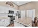 Beautiful kitchen with stainless steel appliances, granite countertops and white cabinetry at 3443 E Thornton Ave, Gilbert, AZ 85297