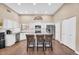 Bright kitchen with white cabinetry, stainless steel appliances, and an island with barstool seating at 3443 E Thornton Ave, Gilbert, AZ 85297