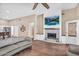 Open living area with fireplace, hardwood floors, and a seamless transition to the kitchen at 3443 E Thornton Ave, Gilbert, AZ 85297