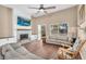 Cozy living room with a stone fireplace, high ceilings, and lots of natural light at 3443 E Thornton Ave, Gilbert, AZ 85297