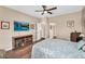 This main bedroom features a ceiling fan, wood-style floors, and neutral paint tones at 3443 E Thornton Ave, Gilbert, AZ 85297