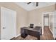 An office space featuring a modern desk, wood-look flooring, and neutral wall color at 3443 E Thornton Ave, Gilbert, AZ 85297
