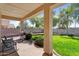 Outdoor patio featuring comfortable seating, a built-in grill, lush landscaping, and serene views of the well-maintained backyard at 3443 E Thornton Ave, Gilbert, AZ 85297