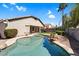 Backyard pool with rock features, desert landscape and covered patio at 3443 E Thornton Ave, Gilbert, AZ 85297