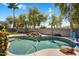 Inviting pool featuring a rock waterfall, lush landscaping, and a basketball hoop for Gathering fun and outdoor enjoyment at 3443 E Thornton Ave, Gilbert, AZ 85297