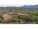 Expansive desert home with tile roof and lush landscaping viewed from above in a natural setting at 36389 N 105Th Pl, Scottsdale, AZ 85262