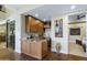 Elegant wet bar featuring wood cabinetry, granite countertop, and adjacent wine cellar at 36389 N 105Th Pl, Scottsdale, AZ 85262