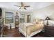 Warm bedroom with wood floors, ceiling fan, multiple windows, and neutral decor creates a relaxing haven at 36389 N 105Th Pl, Scottsdale, AZ 85262
