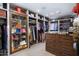 Walk-in closet with custom shelving, drawers, and display case to showcase accessories and clothing at 36389 N 105Th Pl, Scottsdale, AZ 85262
