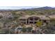Stunning backyard featuring a spacious patio, outdoor kitchen, desert landscaping, and a sparkling pool and spa at 36389 N 105Th Pl, Scottsdale, AZ 85262