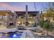Expansive home exterior showcases an outdoor kitchen, fireplace, pool, manicured landscaping, and desert views at 36389 N 105Th Pl, Scottsdale, AZ 85262