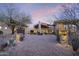 Impressive front exterior of a desert home with grand entrance and lush landscaping at 36389 N 105Th Pl, Scottsdale, AZ 85262