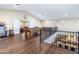 Expansive game room with a pool table, wood flooring, and mezzanine overlooking the kitchen at 36389 N 105Th Pl, Scottsdale, AZ 85262
