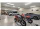 Spacious garage with multiple vehicles and ample storage space with epoxy flooring and lighting at 36389 N 105Th Pl, Scottsdale, AZ 85262