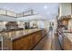 Open-concept kitchen featuring a long island, stainless steel appliances, and wood cabinets at 36389 N 105Th Pl, Scottsdale, AZ 85262