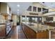 Gourmet kitchen with long center island, stainless appliances, and wood cabinets at 36389 N 105Th Pl, Scottsdale, AZ 85262