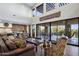 Bright living room with large windows, stone counters, bar seating, and view to outdoor patio at 36389 N 105Th Pl, Scottsdale, AZ 85262