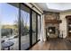 Inviting living room features a stone fireplace, hardwood floors, and sliding doors to a patio with desert views at 36389 N 105Th Pl, Scottsdale, AZ 85262
