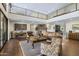 Large living room with soaring ceilings, fireplace, and access to a wine cellar at 36389 N 105Th Pl, Scottsdale, AZ 85262