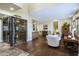 Luxurious living space featuring a glass-enclosed wine room and elegant furnishings at 36389 N 105Th Pl, Scottsdale, AZ 85262