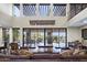 Open living room with high ceilings, exposed beams, and scenic backyard views at 36389 N 105Th Pl, Scottsdale, AZ 85262