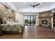 Spacious Primary bedroom with stone accent wall, fireplace, and private patio access at 36389 N 105Th Pl, Scottsdale, AZ 85262