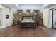 Stylish Primary bedroom featuring a stone accent wall and hardwood floors at 36389 N 105Th Pl, Scottsdale, AZ 85262