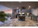 Elegant outdoor kitchen featuring stone accents, built-in grill, and ample counter space with sunset views at 36389 N 105Th Pl, Scottsdale, AZ 85262