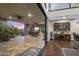 Outdoor living area with a built-in grill, stone columns, and seamless indoor-outdoor flow at 36389 N 105Th Pl, Scottsdale, AZ 85262