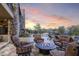 Cozy outdoor seating area with comfortable chairs surrounding a decorative fire pit, with sunset at 36389 N 105Th Pl, Scottsdale, AZ 85262