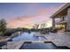 Relaxing backyard oasis with a shimmering pool and spa, perfect for entertaining under colorful sunset at 36389 N 105Th Pl, Scottsdale, AZ 85262