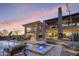 An elegant outdoor area featuring a pool and spa, outdoor dining, and a cozy fireplace at 36389 N 105Th Pl, Scottsdale, AZ 85262