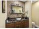 Charming powder room with a decorative mirror, unique vanity, and elegant fixtures at 36389 N 105Th Pl, Scottsdale, AZ 85262