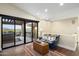 Relaxing sitting room featuring a comfortable couch and balcony with stunning views at 36389 N 105Th Pl, Scottsdale, AZ 85262