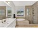 Luxurious bathroom with soaking tub, walk-in shower, and stylish tile accents at 3648 E Arabian Dr, Gilbert, AZ 85296