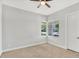 Bedroom featuring neutral carpet and paint, a window with blinds, and a door at 3648 E Arabian Dr, Gilbert, AZ 85296