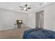 Bedroom with carpet, ceiling fan, tv and a large window at 3648 E Arabian Dr, Gilbert, AZ 85296