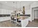 Bright kitchen features white cabinets, stainless steel appliances, large island with bar seating, and decorative backsplash at 3648 E Arabian Dr, Gilbert, AZ 85296