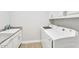 Laundry room with a sink and white cabinets, as well as a washer and dryer at 3648 E Arabian Dr, Gilbert, AZ 85296