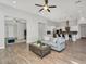 Open-concept living area with wood-look tile flooring, connecting the living room, dining area, and kitchen at 3648 E Arabian Dr, Gilbert, AZ 85296