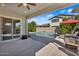 A covered outdoor patio with a ceiling fan overlooks a beautiful backyard pool at 3648 E Arabian Dr, Gilbert, AZ 85296
