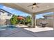 Covered patio featuring a pool, grill, lounge chairs, and pavers at 3648 E Arabian Dr, Gilbert, AZ 85296